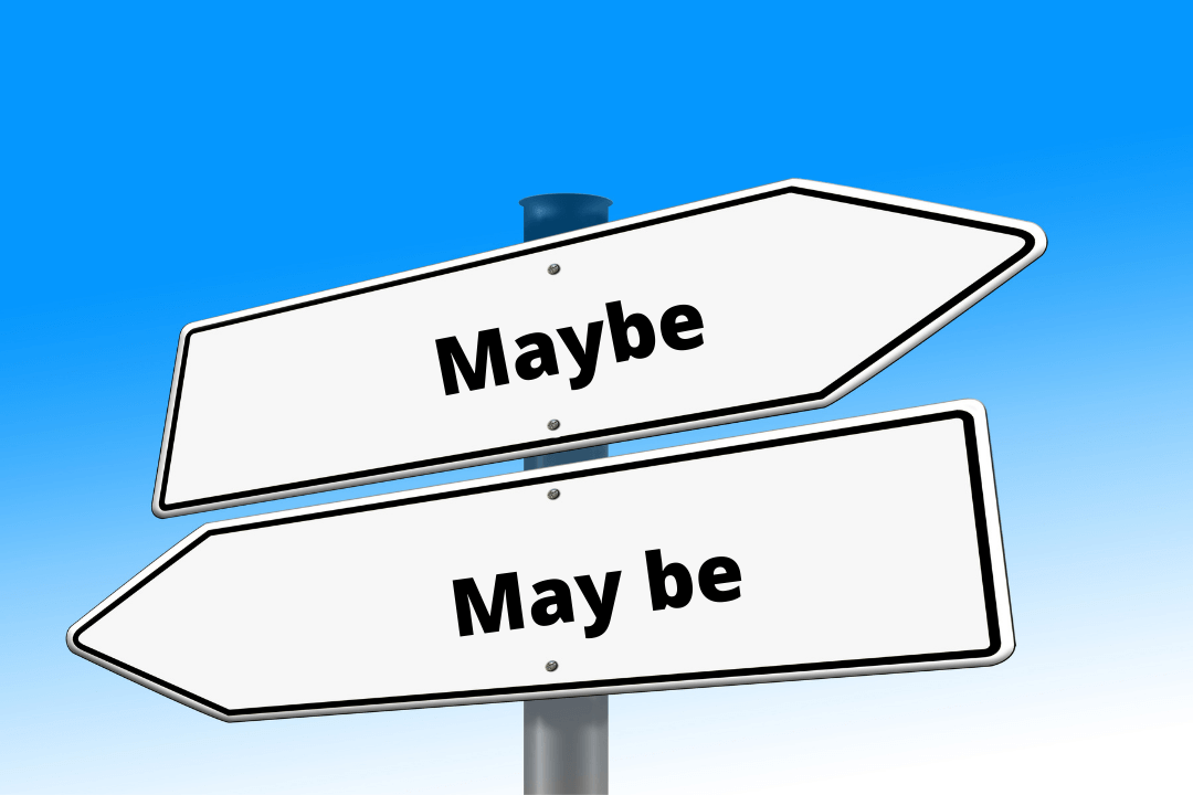 Road signs pointing different directions, one sign reads “maybe” and second one reads “may be”
